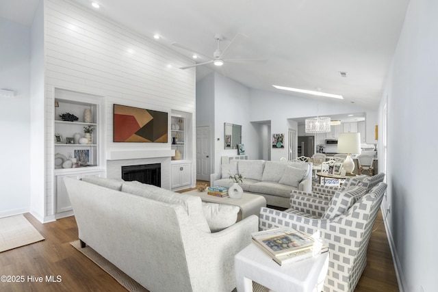 212 Florida Ave, Carolina Beach, NC 28428 - living room with baseboards, dark wood-type flooring, built in shelves, a fireplace, and recessed lighting