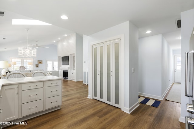 212 Florida Ave, Carolina Beach, NC 28428 - kitchen featuring dark wood-style floors, vaulted ceiling, a ceiling fan, open floor plan, and baseboards