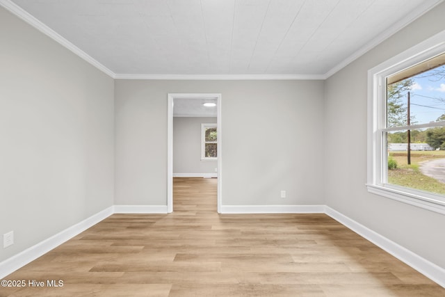 unfurnished room with baseboards, crown molding, and light wood-style floors