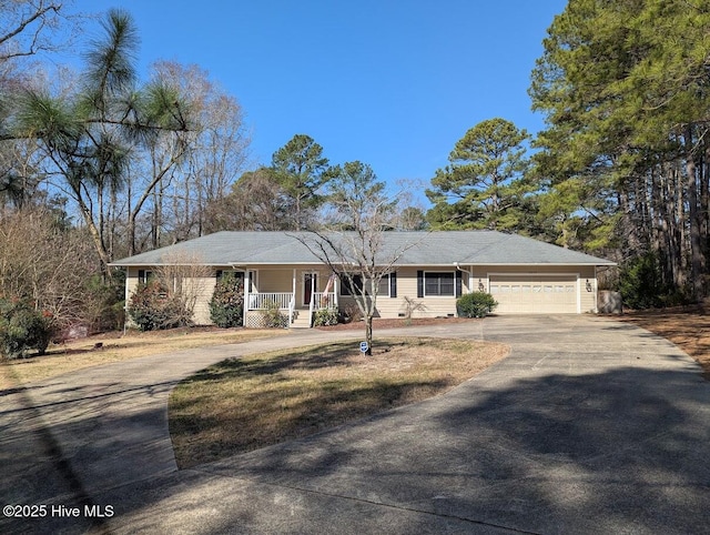 single story home featuring covered porch, concrete driveway, crawl space, and an attached garage