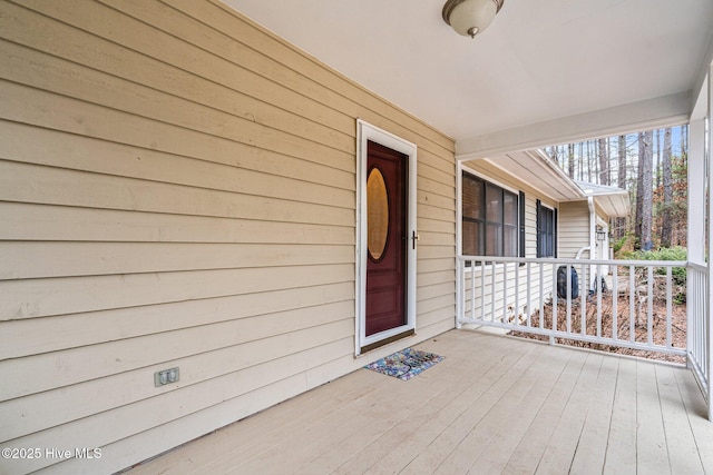 view of exterior entry with covered porch