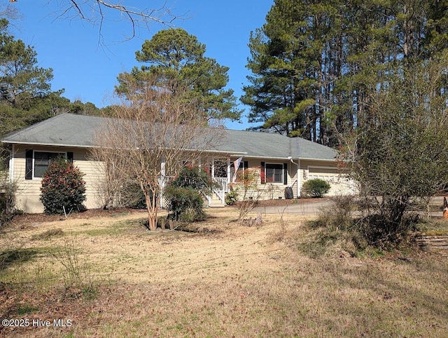 ranch-style house featuring an attached garage and driveway