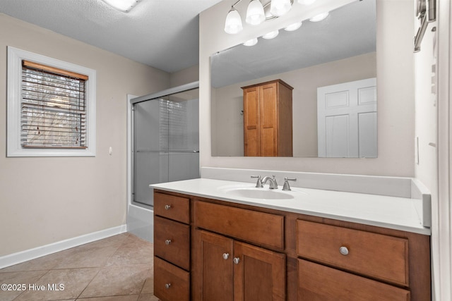 full bathroom featuring enclosed tub / shower combo, tile patterned flooring, vanity, and baseboards