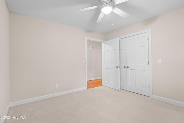 unfurnished bedroom with a closet, carpet flooring, ceiling fan, and baseboards