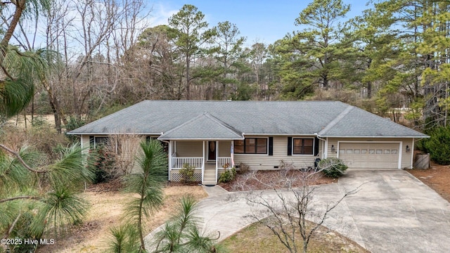 ranch-style home featuring concrete driveway, roof with shingles, an attached garage, covered porch, and crawl space