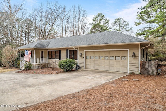 ranch-style house featuring covered porch, driveway, roof with shingles, and an attached garage