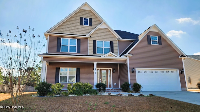 view of front of home featuring concrete driveway, a porch, and an attached garage