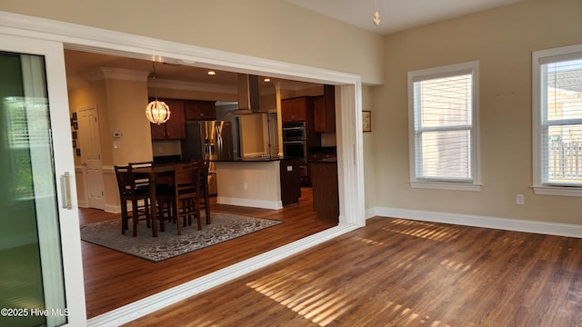 unfurnished dining area with dark wood finished floors and baseboards