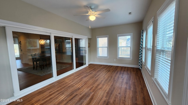 unfurnished sunroom featuring visible vents and ceiling fan