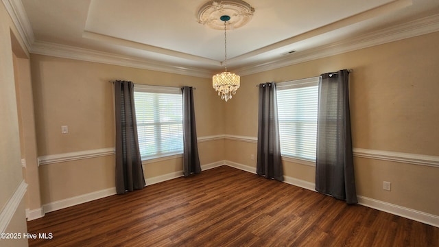 empty room featuring dark wood-style flooring, plenty of natural light, and baseboards