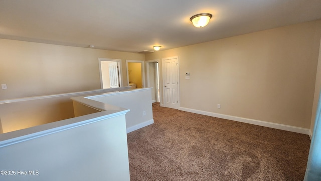 spare room with carpet flooring and baseboards