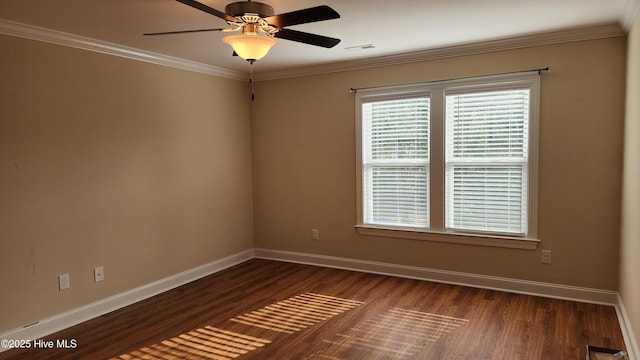 empty room with dark wood-style flooring, visible vents, a ceiling fan, baseboards, and ornamental molding