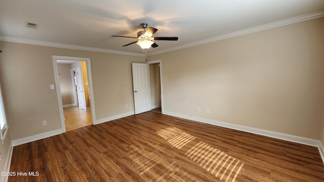 unfurnished bedroom featuring visible vents, baseboards, wood finished floors, and ornamental molding