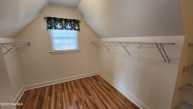 walk in closet with vaulted ceiling and wood finished floors