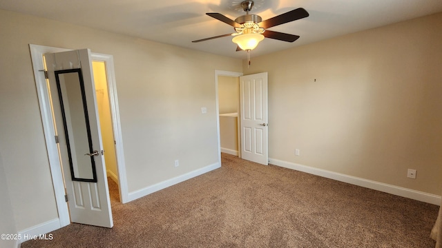 unfurnished bedroom with a ceiling fan, carpet flooring, and baseboards