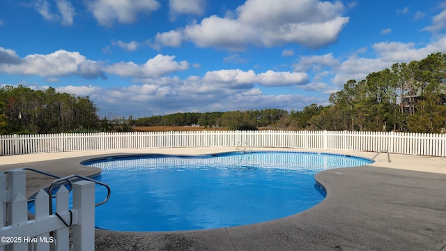 view of pool with a fenced in pool, fence, and a patio