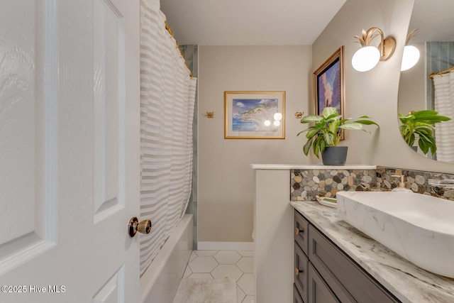 bathroom featuring tile patterned flooring, baseboards, shower / tub combo with curtain, and vanity