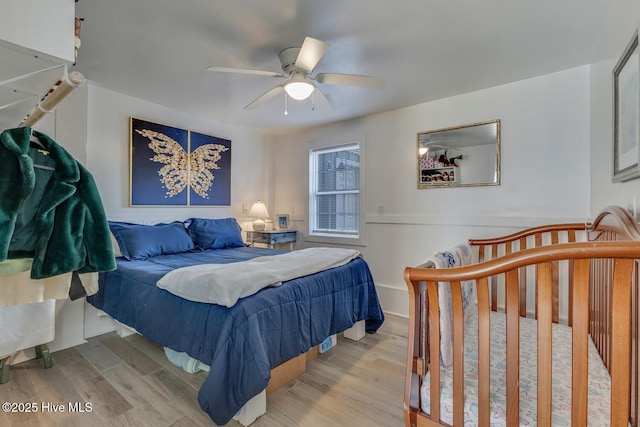 bedroom with ceiling fan and light wood-style flooring