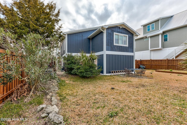 exterior space with a fenced backyard and a yard