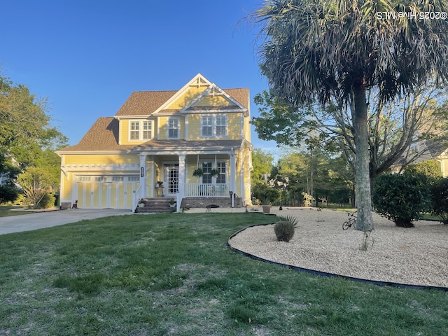 view of front of property featuring a porch, a front yard, concrete driveway, and an attached garage