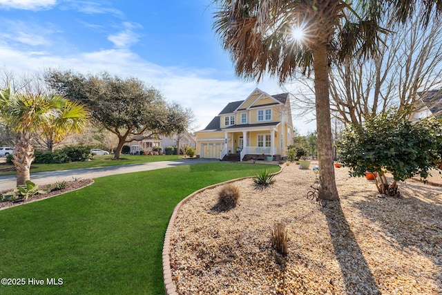 view of front facade featuring a garage, driveway, a porch, and a front yard