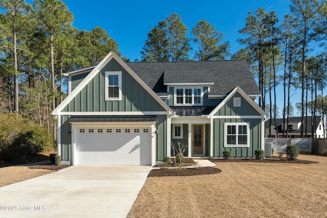 view of front of house with metal roof, concrete driveway, roof with shingles, board and batten siding, and a standing seam roof