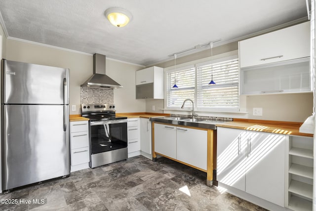 kitchen featuring crown molding, stainless steel appliances, wooden counters, white cabinets, and wall chimney range hood