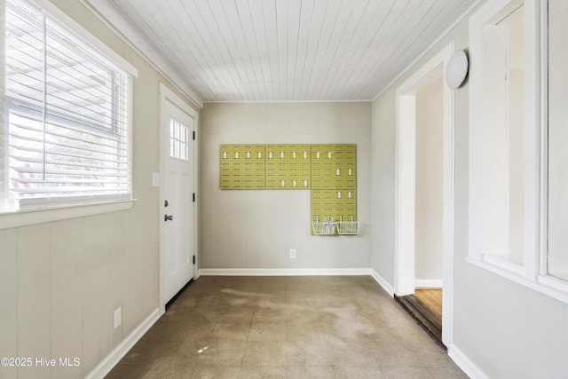 doorway to outside featuring wood ceiling and baseboards