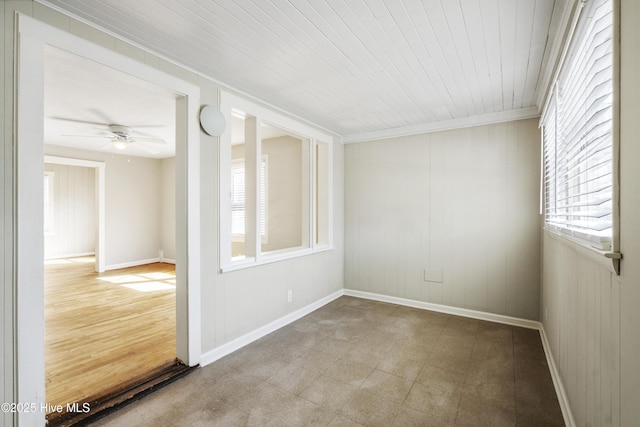 empty room with baseboards, ceiling fan, and tile patterned floors