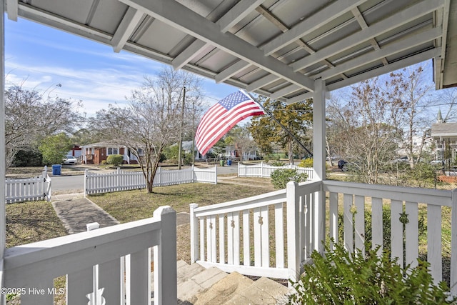 exterior space with covered porch and fence