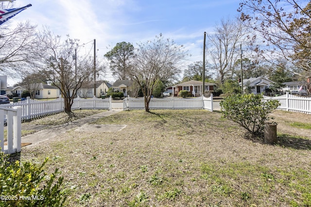 view of yard featuring a fenced front yard and a residential view