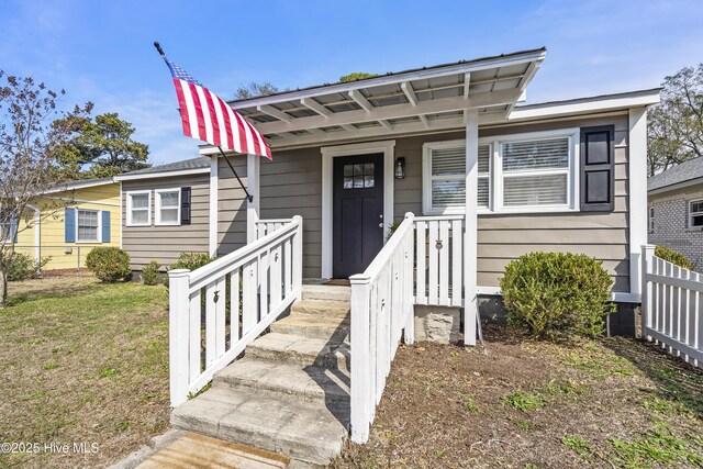 bungalow-style home with a front lawn