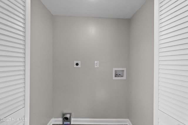 laundry area with laundry area, hookup for a washing machine, electric dryer hookup, and baseboards