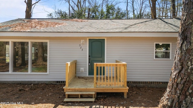 back of property featuring a shingled roof, crawl space, and a wooden deck