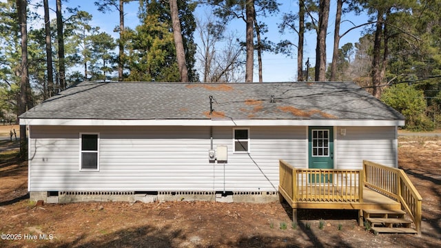 rear view of house with crawl space, roof with shingles, and a deck