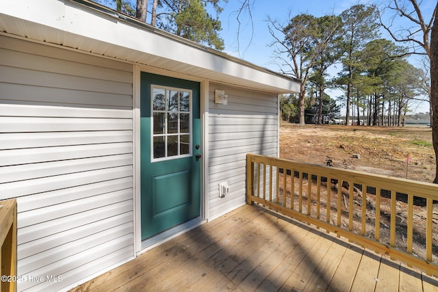 entrance to property featuring a wooden deck