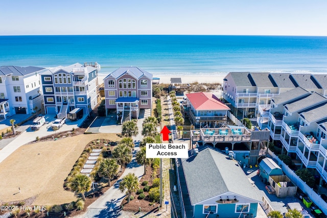 bird's eye view with a water view and a beach view