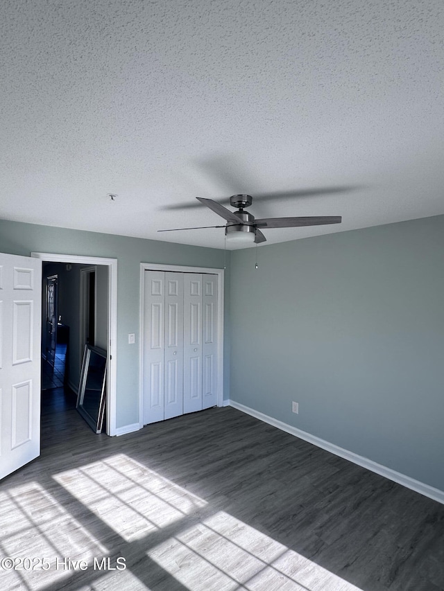 unfurnished bedroom with a textured ceiling and wood finished floors