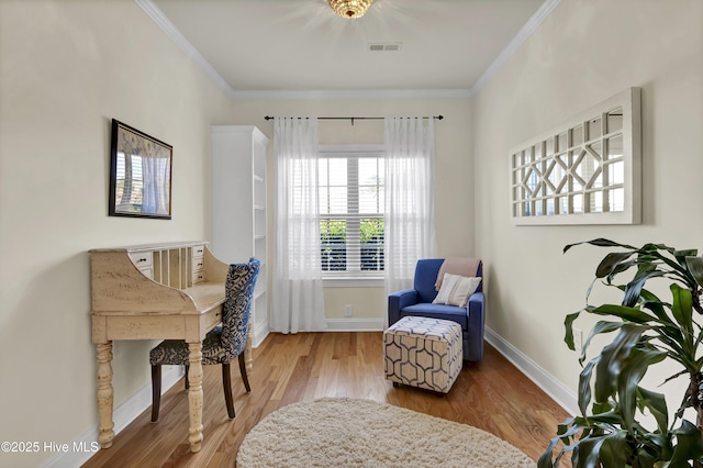 living area featuring ornamental molding, wood finished floors, visible vents, and baseboards