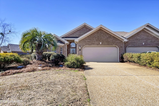 single story home with an attached garage, concrete driveway, and brick siding