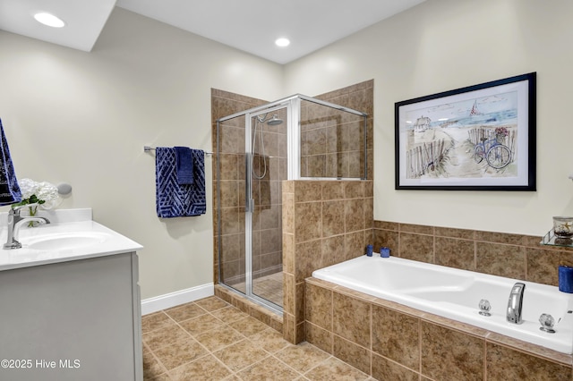 bathroom with a garden tub, a shower stall, vanity, and tile patterned floors