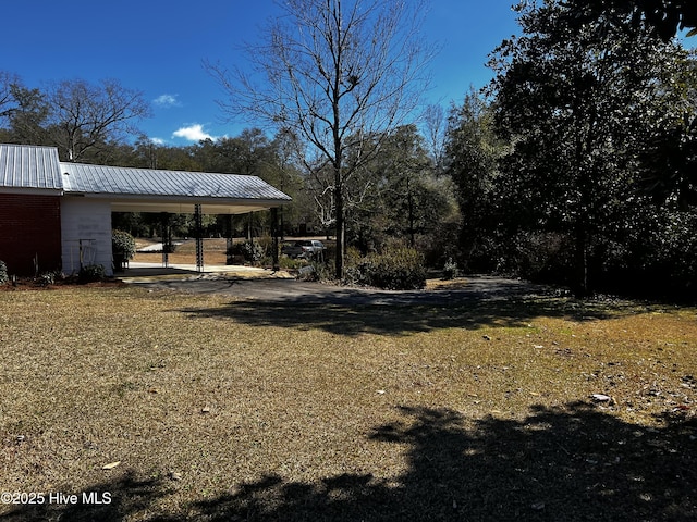 view of yard with an attached carport