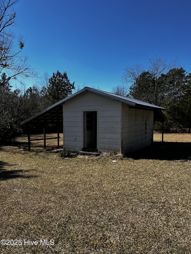 view of outbuilding featuring a carport and an outdoor structure