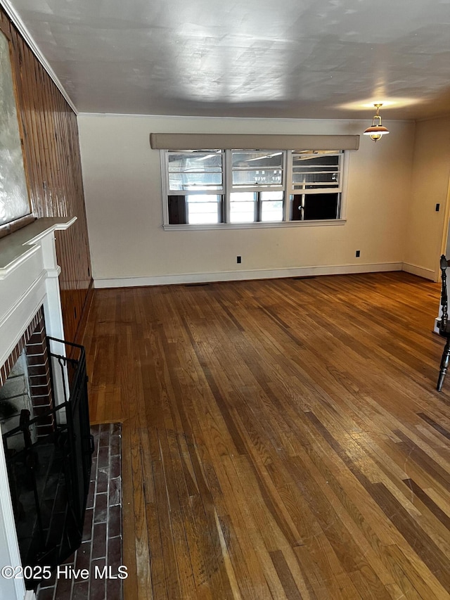 323 Hoover Rd, White Oak, NC 28399 - unfurnished living room with hardwood / wood-style flooring, a brick fireplace, and baseboards