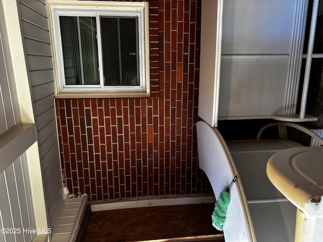 bathroom featuring wooden walls