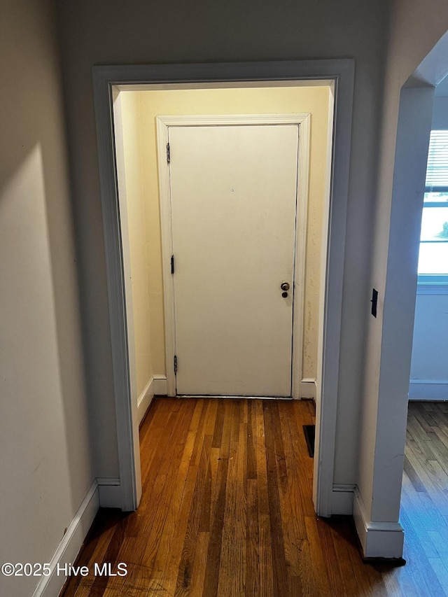 entryway featuring dark wood finished floors and baseboards