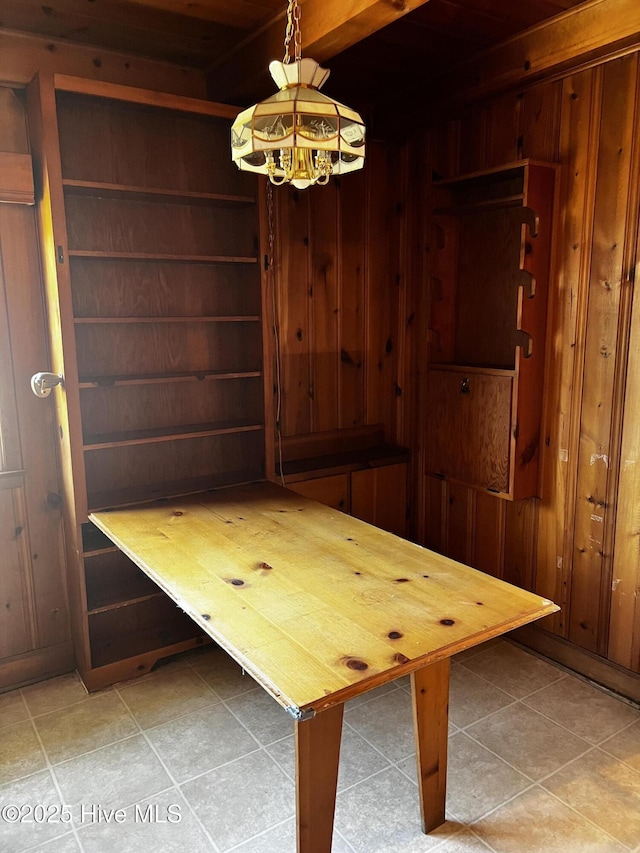 unfurnished dining area featuring a sauna, wooden walls, and tile patterned floors