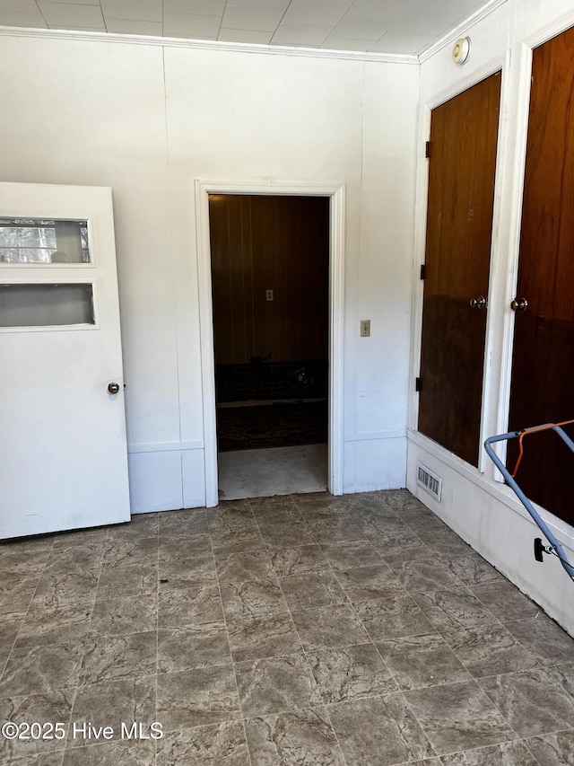 interior space featuring visible vents and wood walls