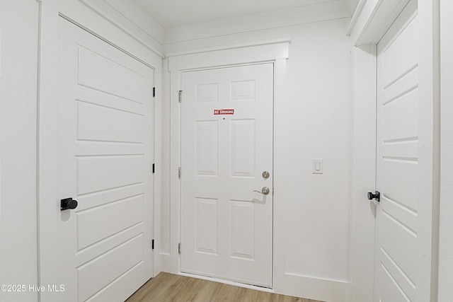 doorway to outside with light wood-style flooring