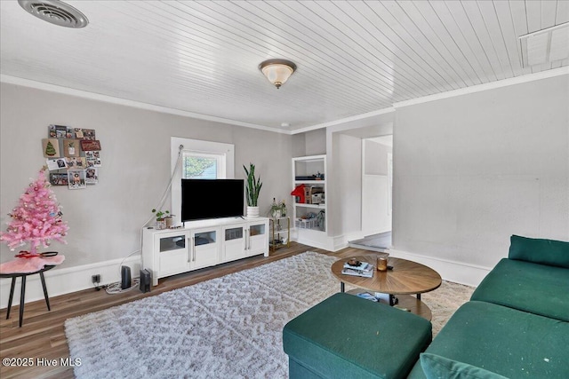 living room featuring dark wood-style flooring, visible vents, ornamental molding, wooden ceiling, and baseboards